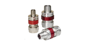 Three Crouse-Hinds Terminator II TMCX cable glands of varying sizes made of polished aluminum, featuring a distinctive red anodized nut in the center and threaded NPT entry points.