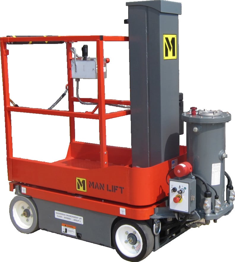 A compact, industrial MVL16EX explosion-proof vertical mast man lift featuring a 27 x 36 inch platform and a 21 ft 6 in working height. The unit is finished in high-visibility safety yellow and includes proportional drive controls, a movement alarm, and an integrated battery charging system. It is specifically engineered with a 'T-Box' design to separate the motor from controls for Class 1, Division 1, Group D hazardous environments.