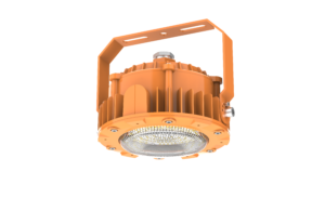 Yellow industrial LED explosion-proof light fixture with a rugged, finned aluminum heat sink housing. The unit features a heavy-duty adjustable orange mounting bracket and is shown with both a flat tempered glass lens and a high-impact dome lens variant.