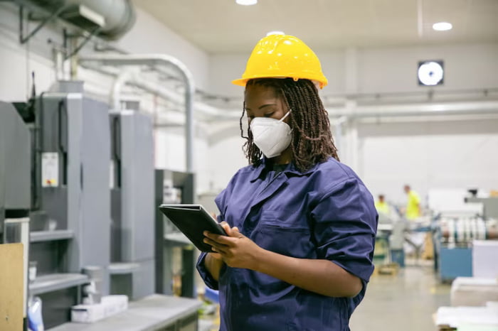 industrial worker holding ATEX-compliant tablet